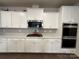 Well-equipped kitchen with white cabinets, stainless steel appliances, and a stylish tile backsplash at 21110 Bank Fire Ln, Huntersville, NC 28078