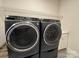 Modern laundry room with front-loading washer and dryer, featuring sleek design and efficient appliances at 21110 Bank Fire Ln, Huntersville, NC 28078