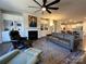 Comfortable living room features a fireplace, built-in shelving, hardwood floors and comfortable furnishings at 21110 Bank Fire Ln, Huntersville, NC 28078