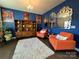 Bright and eclectic living room with blue walls, unique decor, and a cozy seating area, perfect for relaxing and entertaining at 21110 Bank Fire Ln, Huntersville, NC 28078