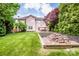 Spacious backyard with a patio, dining set, and mature trees at 219 Pleasant Grove Ln, Mooresville, NC 28115