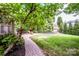Inviting backyard featuring a well-maintained lawn, brick patio, and lush landscaping, perfect for outdoor enjoyment at 219 Pleasant Grove Ln, Mooresville, NC 28115