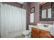 Cozy bathroom with shower and bath, clean toilet, and decorative mirror at 219 Pleasant Grove Ln, Mooresville, NC 28115