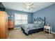 Comfortable bedroom with blue walls, patterned bedding, and bright window at 219 Pleasant Grove Ln, Mooresville, NC 28115