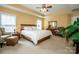 Bright, spacious bedroom with natural light, ceiling fan, and neutral decor at 219 Pleasant Grove Ln, Mooresville, NC 28115