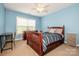 A comfortably furnished bedroom featuring a wooden bed frame and ample natural light at 219 Pleasant Grove Ln, Mooresville, NC 28115