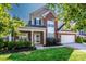 Charming two-story brick home with a well-manicured lawn and inviting front porch at 219 Pleasant Grove Ln, Mooresville, NC 28115
