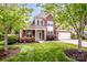 Charming two-story brick home featuring a well-manicured lawn and inviting front porch at 219 Pleasant Grove Ln, Mooresville, NC 28115