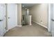 Upstairs hallway featuring multiple doors with neutral wall color at 219 Pleasant Grove Ln, Mooresville, NC 28115