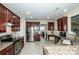 Spacious kitchen featuring granite countertops, stainless steel appliances, and ample cabinet space at 219 Pleasant Grove Ln, Mooresville, NC 28115