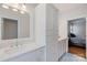 Modern bathroom featuring white cabinetry, quartz countertop, and decorative tile flooring at 2306 Club Rd, Charlotte, NC 28205