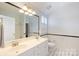 Bright bathroom features a double vanity, large mirror, and classic black-and-white tile floor at 2306 Club Rd, Charlotte, NC 28205