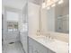 Elegant bathroom featuring custom vanity, drawers, quarts countertop, patterned floor tiles, and modern fixtures at 2306 Club Rd, Charlotte, NC 28205