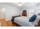 Bright bedroom featuring a sleigh bed, shuttered windows, hardwood floors, and neutral decor at 2306 Club Rd, Charlotte, NC 28205