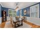 Elegant dining room with rustic chandelier, blue walls, and ample natural light at 2306 Club Rd, Charlotte, NC 28205
