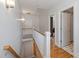 Hallway with hardwood flooring and white staircase leading to an upper level at 2306 Club Rd, Charlotte, NC 28205