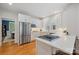 Modern kitchen featuring stainless steel appliances, white cabinets, quartz countertops, and a gas cooktop at 2306 Club Rd, Charlotte, NC 28205