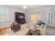 Inviting living room featuring a comfortable sofa, decorative pillows, and a traditional entertainment center at 2306 Club Rd, Charlotte, NC 28205