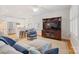 Cozy living room with a large sectional sofa, stylish TV stand, and an open view to the kitchen at 2306 Club Rd, Charlotte, NC 28205