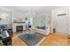 Bright living room with fireplace, modern chandelier, hardwood floors, and stylish decor at 2306 Club Rd, Charlotte, NC 28205