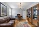 Office area featuring hardwood floors, a desk, a sofa, a cabinet, and natural light at 2306 Club Rd, Charlotte, NC 28205