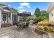 Charming backyard patio with dining set, grill, lush landscaping, and lovely flower beds at 2306 Club Rd, Charlotte, NC 28205