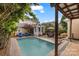 Beautiful backyard with a pool, outdoor dining area, cozy lounge chairs, and a covered porch at 2306 Club Rd, Charlotte, NC 28205