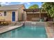 Serene pool with a covered seating, a small waterfall feature, and easy access to the house at 2306 Club Rd, Charlotte, NC 28205