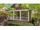 Charming front porch with white railings, brick foundation, and decorative hanging plants at 2306 Club Rd, Charlotte, NC 28205