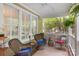 Inviting front porch with comfortable wicker seating, ferns, and a ceiling fan at 2306 Club Rd, Charlotte, NC 28205