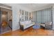 Cozy sunroom with wicker furniture, wood floors, and large windows at 2306 Club Rd, Charlotte, NC 28205