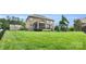 Well-maintained backyard with lush green lawn, play set, and a charming screened porch perfect for relaxation at 2655 Stonewood Vw, Kannapolis, NC 28081