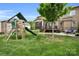 A backyard featuring a playset, outdoor seating area, a porch, grill, and lush greenery at 2655 Stonewood Vw, Kannapolis, NC 28081