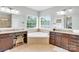 Bright bathroom with a corner soaking tub, double vanities, and large windows offering plenty of natural light at 2655 Stonewood Vw, Kannapolis, NC 28081