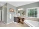 Well-lit bathroom with a granite vanity, a luxurious soaking tub, and a separate shower, creating a spa-like experience at 2655 Stonewood Vw, Kannapolis, NC 28081