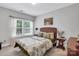 Bright bedroom featuring a wicker headboard, side table, and natural light at 2655 Stonewood Vw, Kannapolis, NC 28081