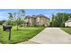 A two-story brick home with a well-manicured lawn, landscaped garden beds, and a long concrete driveway at 2655 Stonewood Vw, Kannapolis, NC 28081