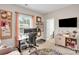 A functional home office with a built-in workspace, tv, shelving, and access to a modern bathroom at 2655 Stonewood Vw, Kannapolis, NC 28081