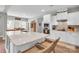 Bright kitchen boasts an island with seating, white cabinets, and stainless steel appliances at 2655 Stonewood Vw, Kannapolis, NC 28081
