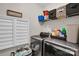 Functional laundry room with modern washer and dryer, storage shelves, and ample space for sorting and folding at 2655 Stonewood Vw, Kannapolis, NC 28081
