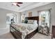 Bright, spacious main bedroom featuring a tray ceiling, a king-size bed, and a view into the exercise room at 2655 Stonewood Vw, Kannapolis, NC 28081