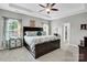 Spacious main bedroom featuring a large bed, tray ceiling, and ample natural light from the bright windows at 2655 Stonewood Vw, Kannapolis, NC 28081