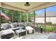 Relaxing screened porch with comfortable seating and an outdoor view of the landscaped backyard at 2655 Stonewood Vw, Kannapolis, NC 28081