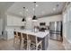 Modern kitchen features a spacious island with seating, stainless steel appliances, and stylish pendant lighting at 3029 Trace Meadow Ct, York, SC 29745