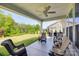 Covered patio with ceiling fan, comfortable seating and a view of the manicured lawn at 3029 Trace Meadow Ct, York, SC 29745