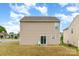 Home's backyard with a green Adirondack chair, small patio, green lawn, and a sliding glass door at 3033 Green Apple Dr, Dallas, NC 28034