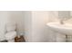 Simple half bathroom with a pedestal sink and toilet at 3033 Green Apple Dr, Dallas, NC 28034