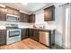 Well-equipped kitchen with stainless steel appliances and dark wood cabinets at 3033 Green Apple Dr, Dallas, NC 28034