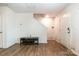 Bright living room with hardwood floors, a staircase, and a white door at 3033 Green Apple Dr, Dallas, NC 28034