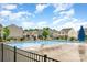 Community pool surrounded by lounge chairs and townhomes on a sunny day with partly cloudy skies at 3033 Green Apple Dr, Dallas, NC 28034